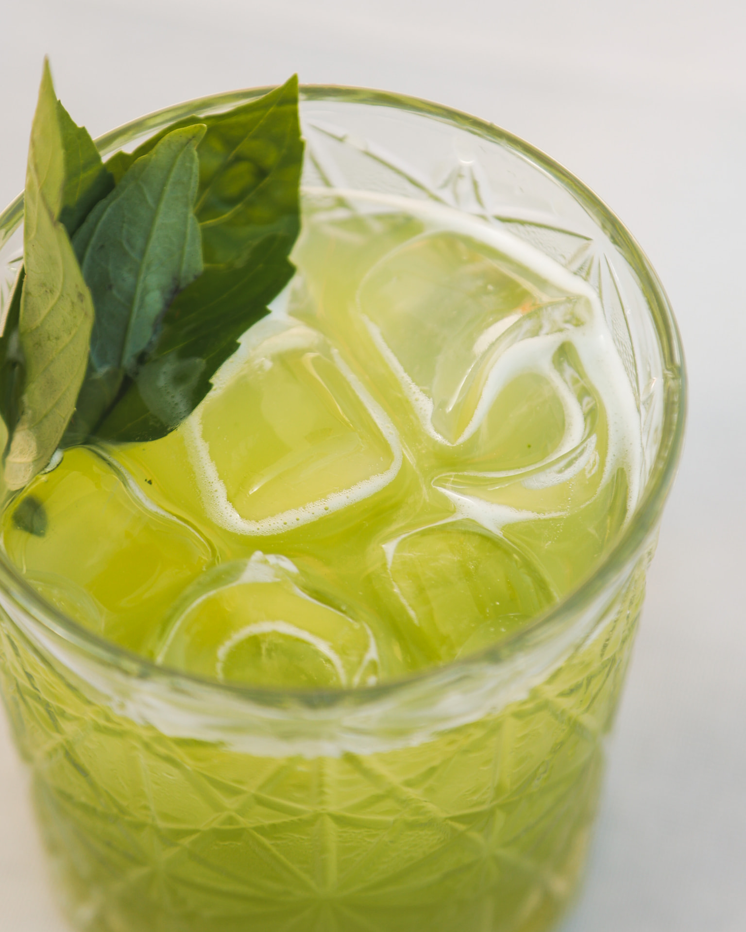 Fresh green cocktail with basil and ice at Nōesis